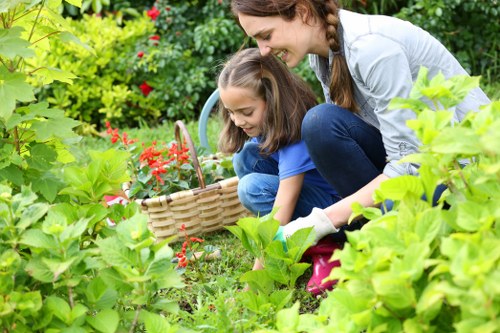 Gardener working safely with tools and protective equipment
